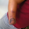 Arm thumb tattoo
