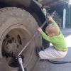 Kid fixes truck wheel Kid fixes truck wheel