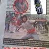 Protester aims a Nokia at riot police Protester aims a Nokia at riot police