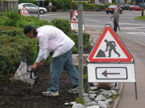 Man with umbrella sign